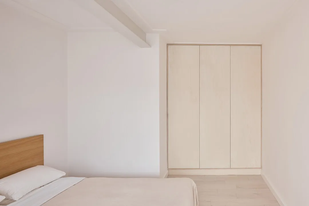 Minimalist biophilic Japandi bedroom — fitted joinery and wardrobe